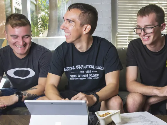 Three Army ROTC students observing program on laptop computer