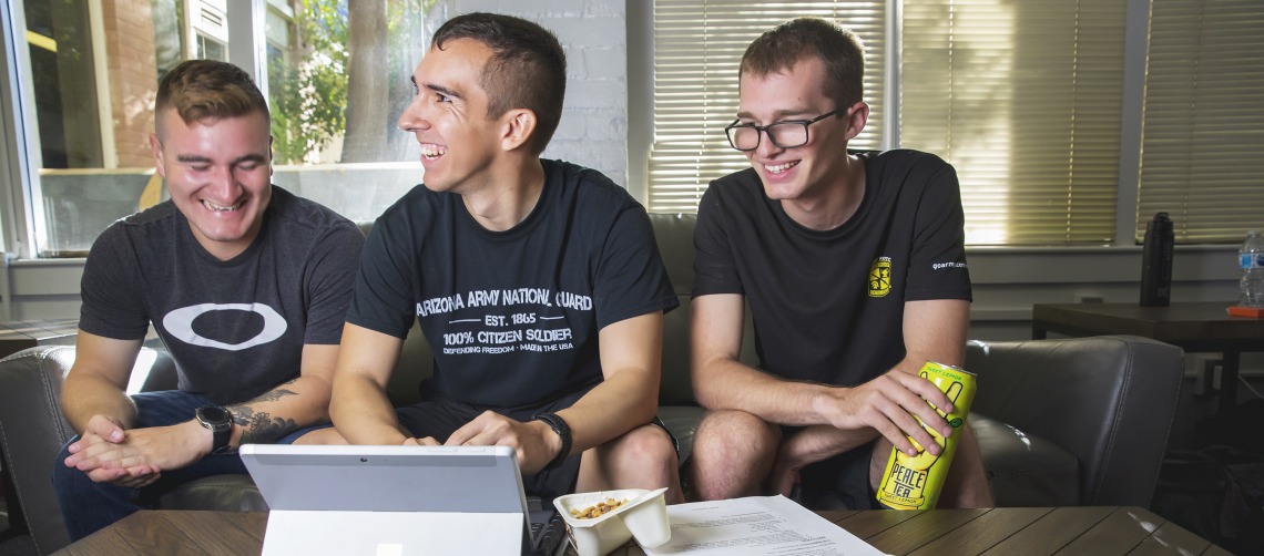 Three Army ROTC students observing program on laptop computer